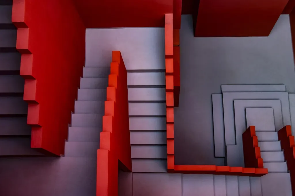 vivid red and pale pink walls of Ricardo Bofill’s La Muralla Roja create a maze of geometric forms
