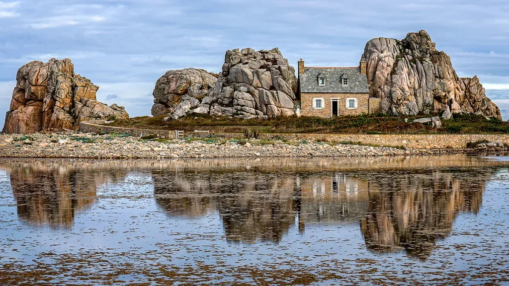 cottage tucked amongst rugged rocky landscape