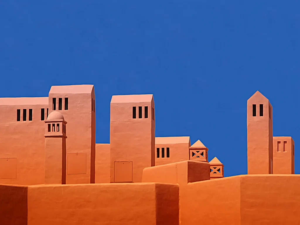 terracotta buildings against bright blue sky