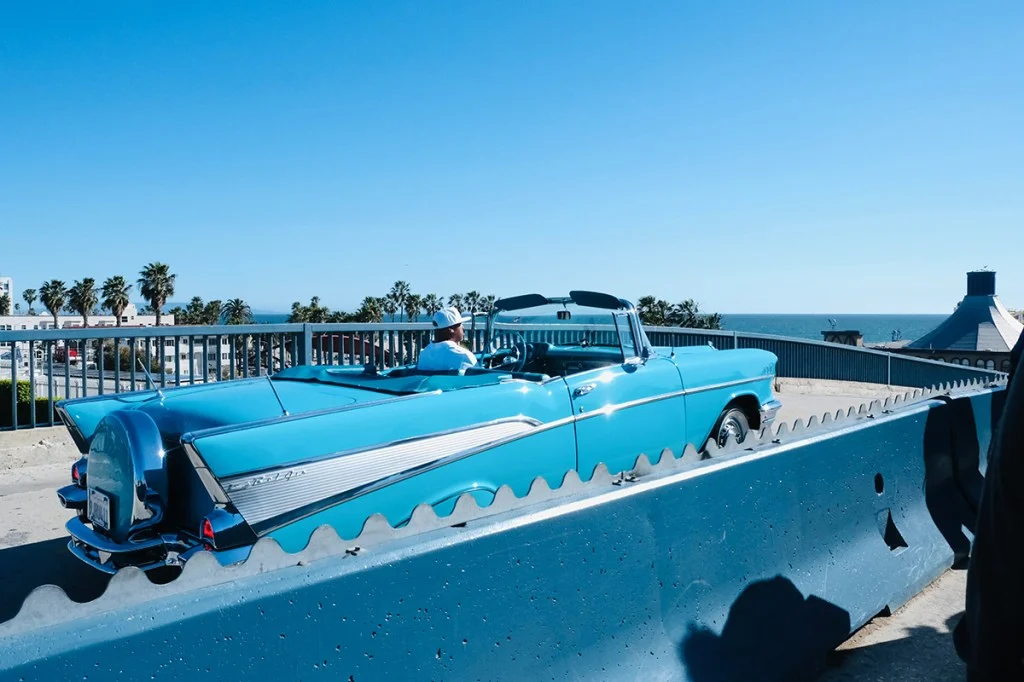 blue car against blue architecture and sky