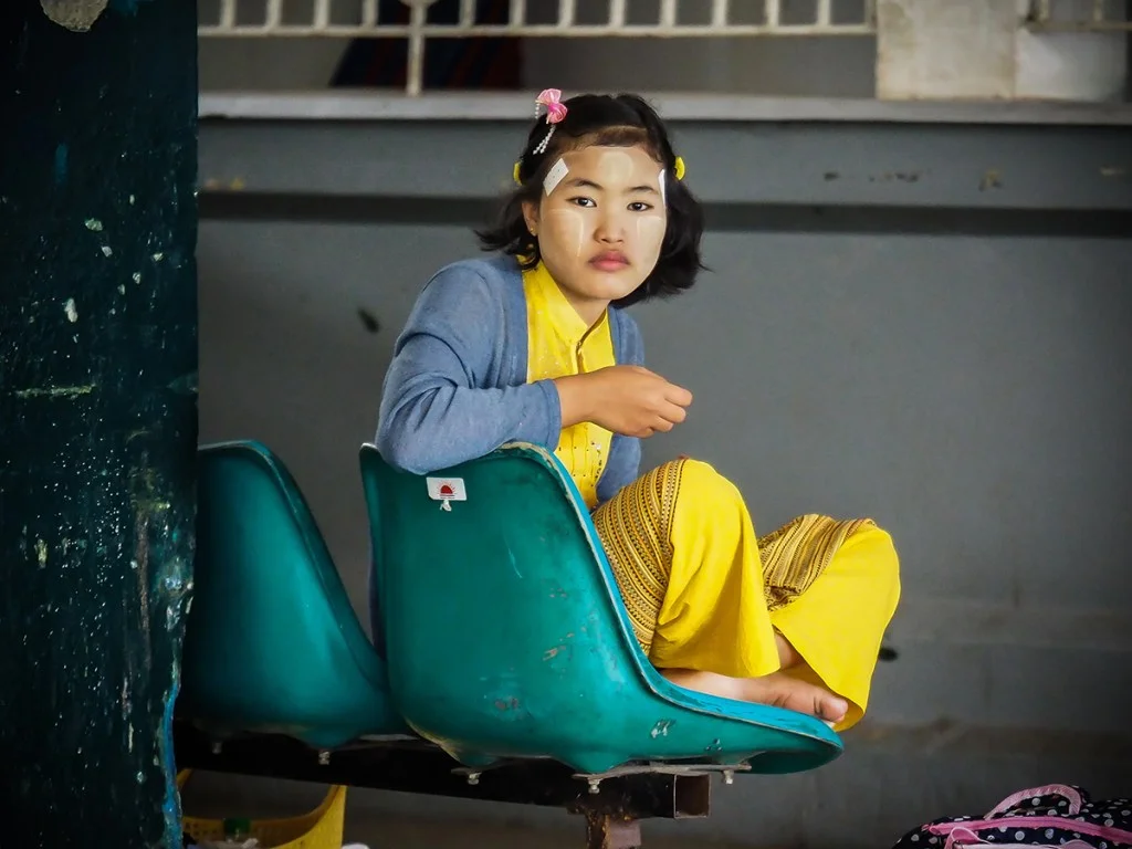 girl in yellow sat on teal blue chair
