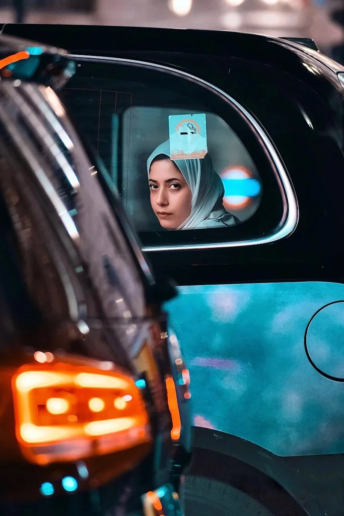 woman looking out of a black cab