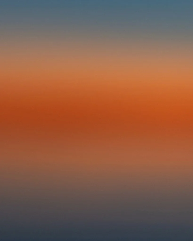 Abstract sunset photo showing bands of orange and blue