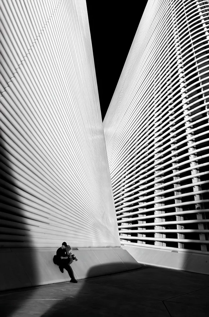 person leaning against large building