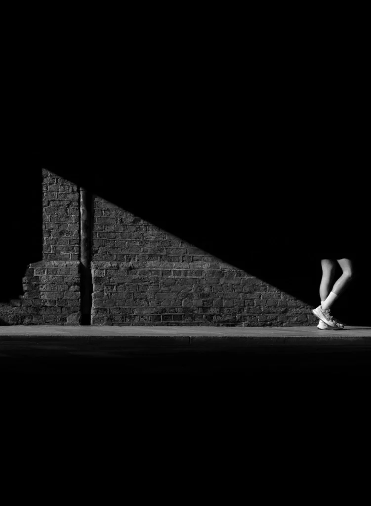 photo of person walking into a shadow