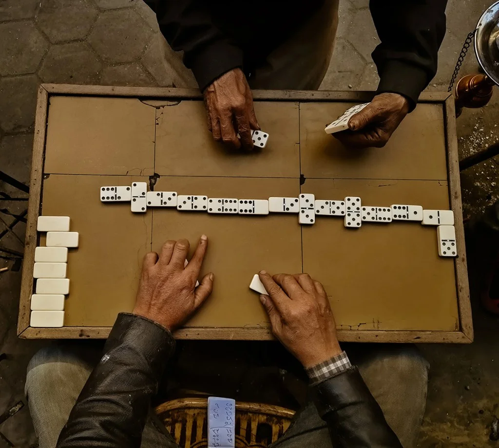 Overhead shot of people playing dominoes