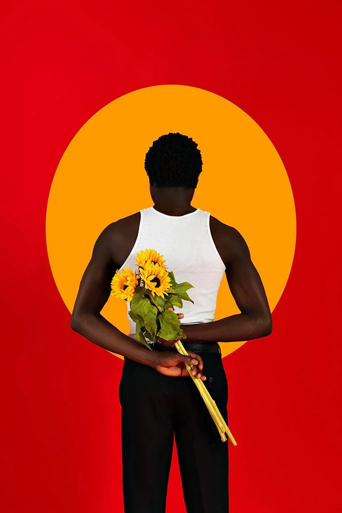 Portrait of a person against yellow circle and red background