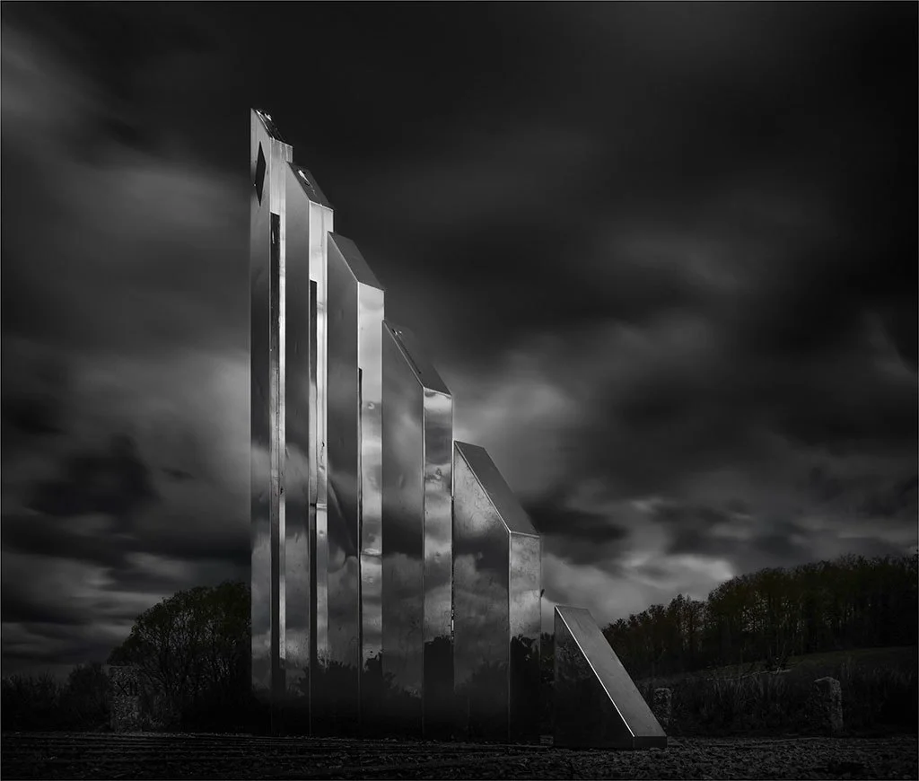 Mysterious sculptures under dramatic clouds