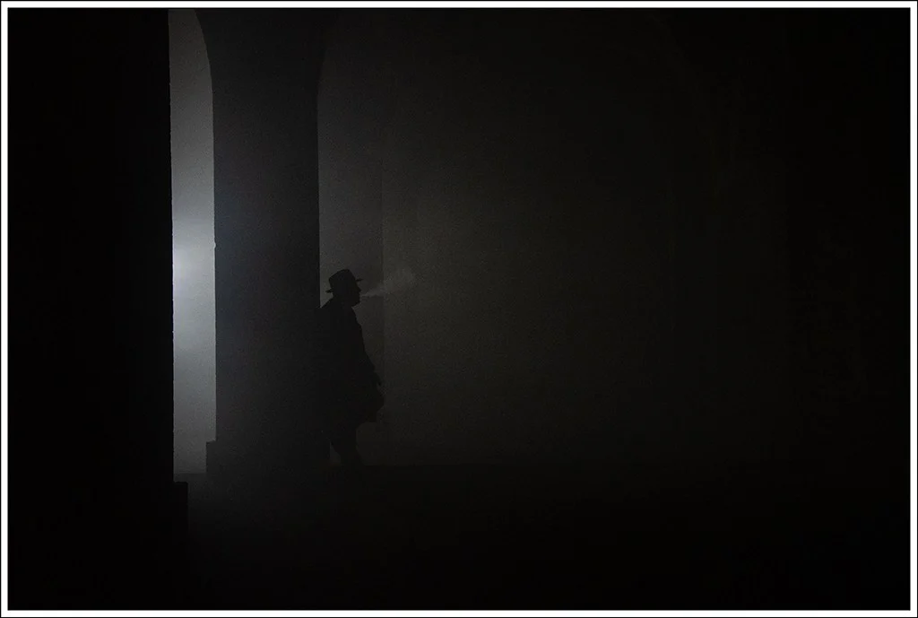 Low light street scene with silhouette of a man
