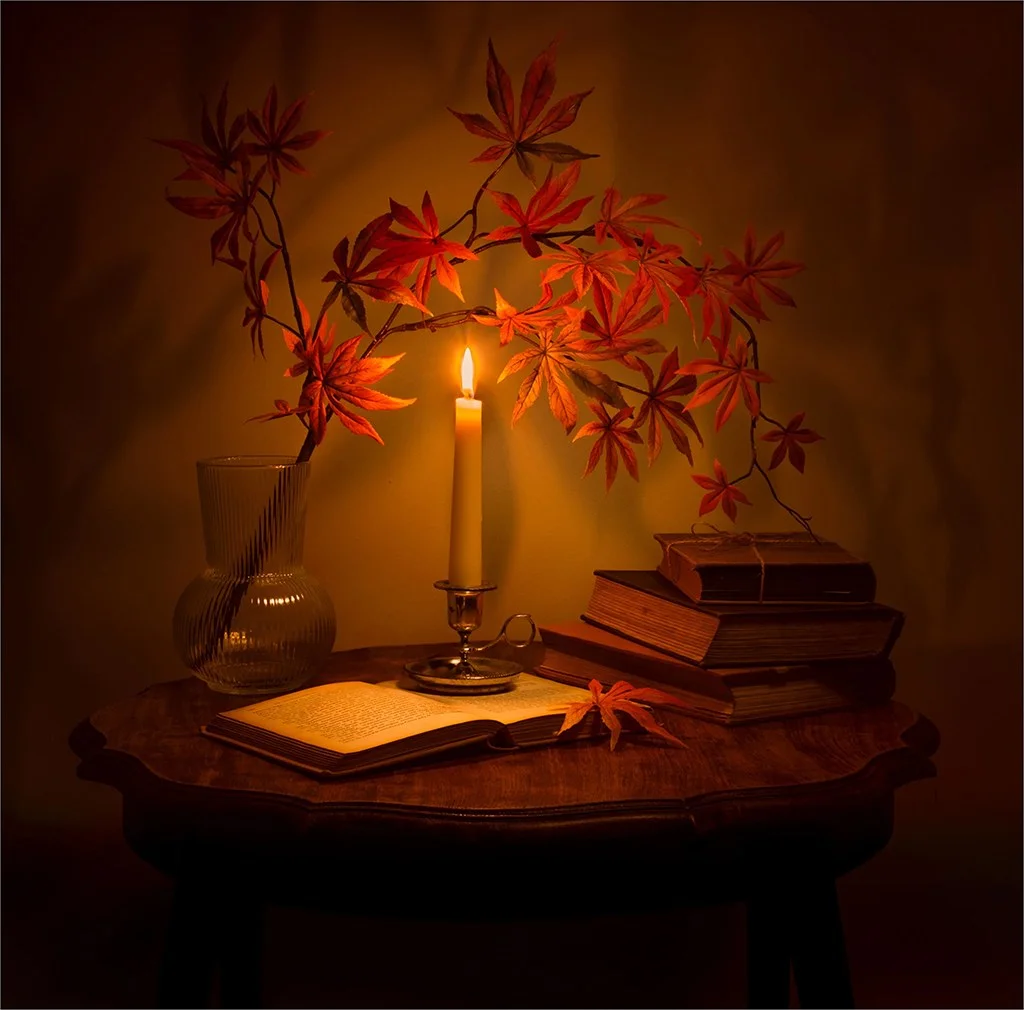 Candle and leaves in low light