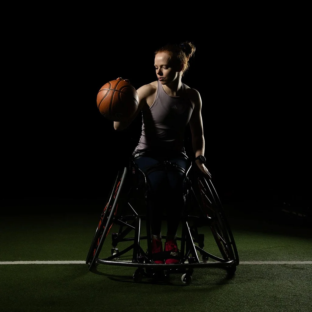 Portrait of a girl in a wheelchair with basketball
