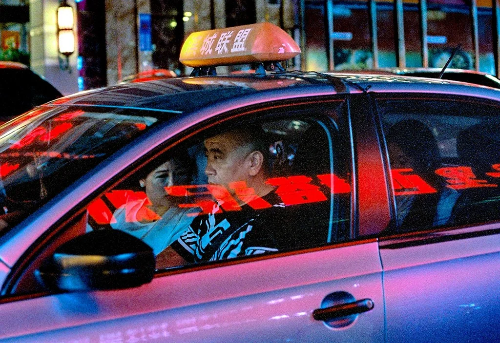 Film photo of a taxi at night