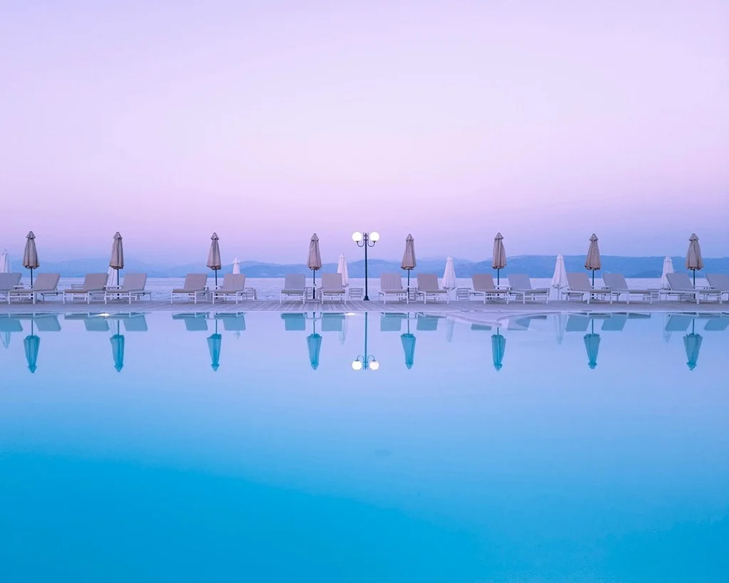 purple sky against blue pool
