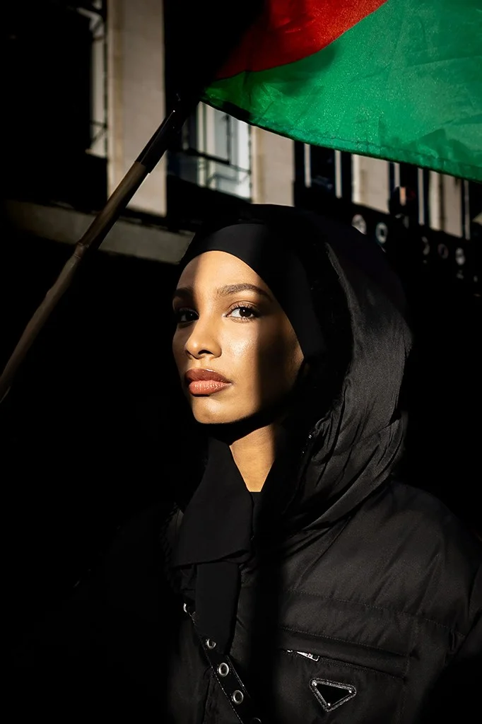 Portrait of a protester with light casting over her eye
