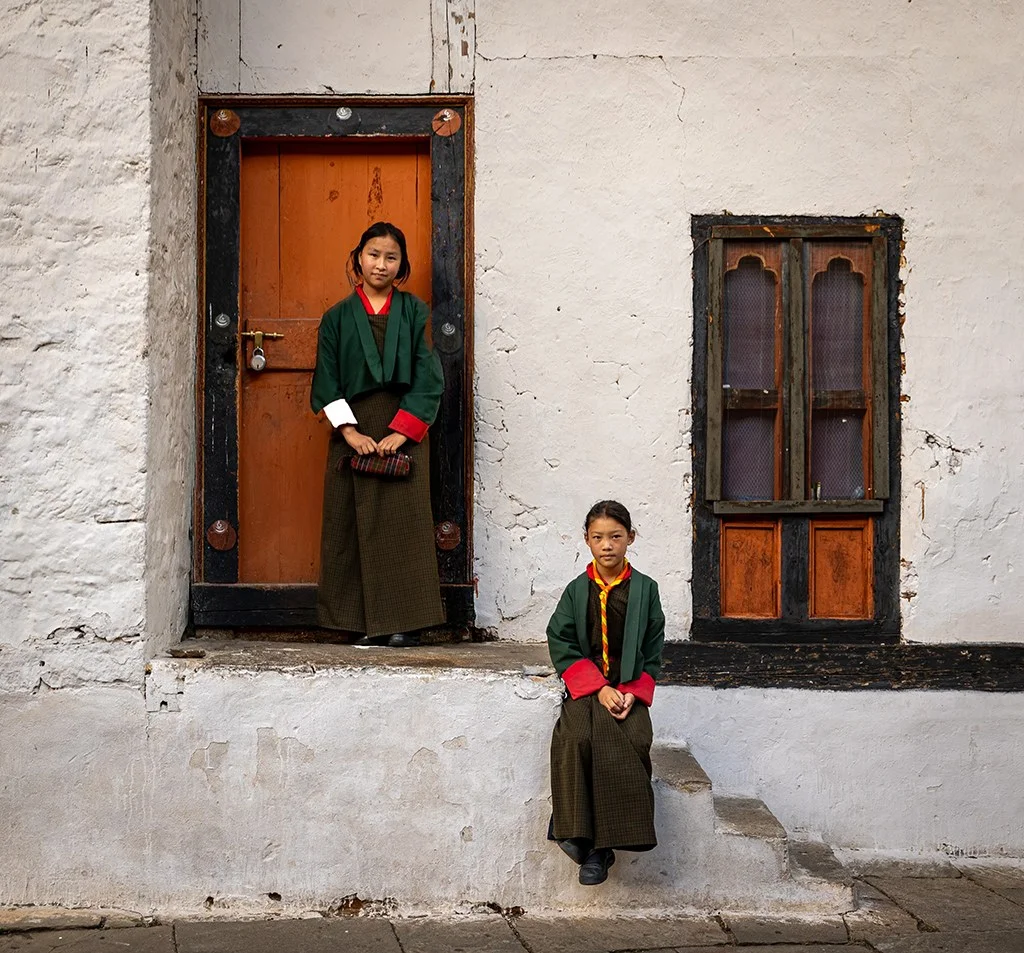 Schoolgirls in front of colorful architecture in Bhutan