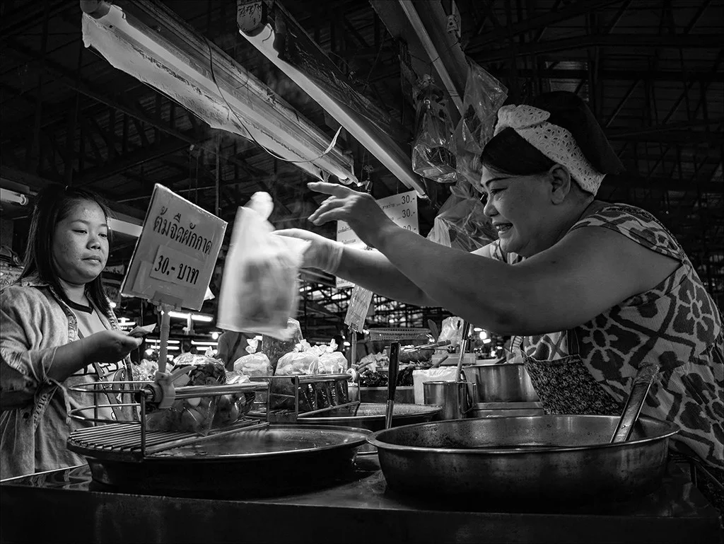 Street food vendor engaging with a customer