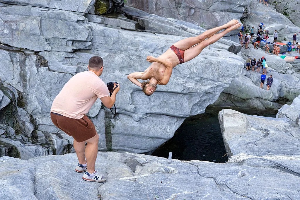 Photographer capturing a diver in mid-air