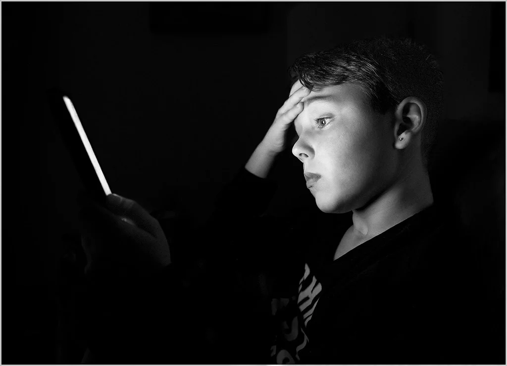 Young boy looking at a screen