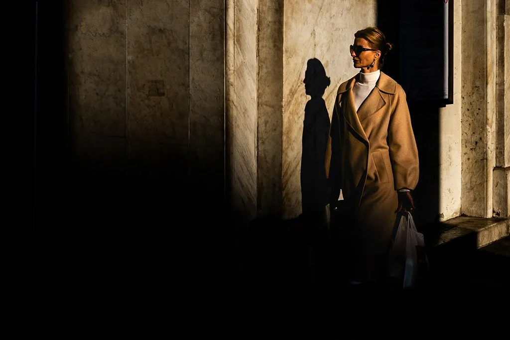 Chic woman walking into shadows