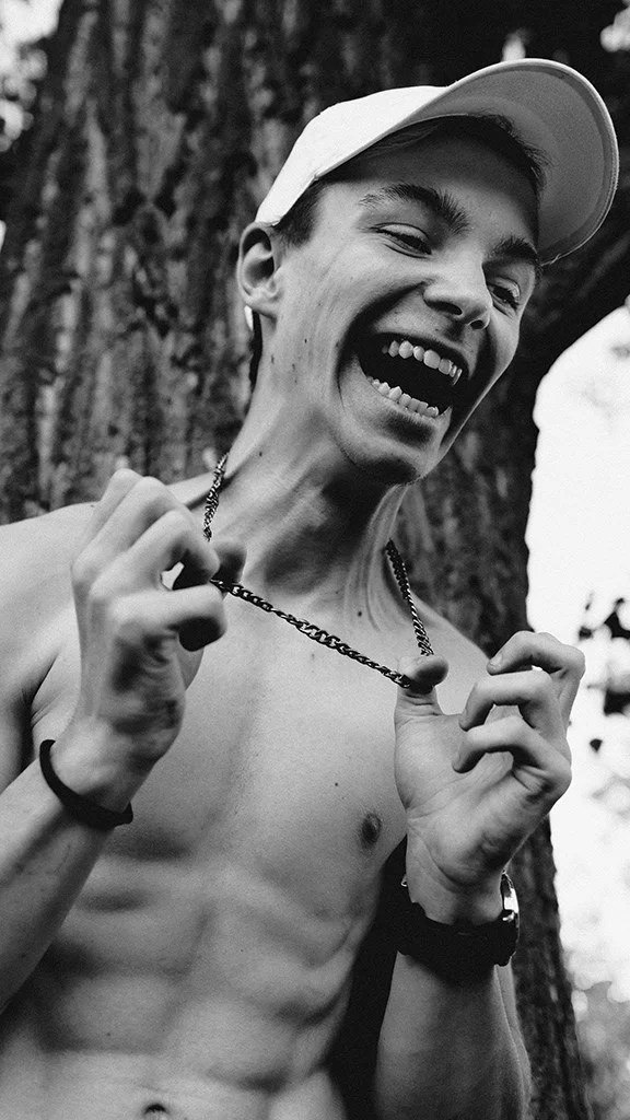 Young man laughing while holding a chain