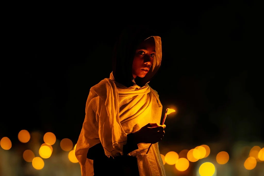 Boy holding a candle during a religious ceremony in Ethiopia