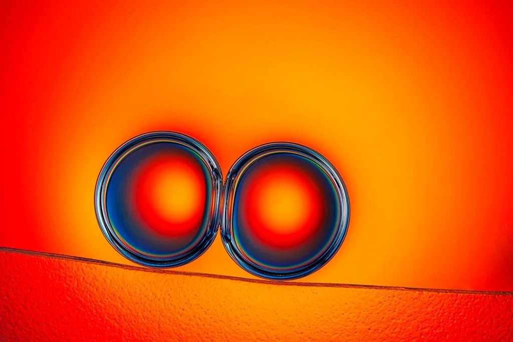 two oil droplets on orange background