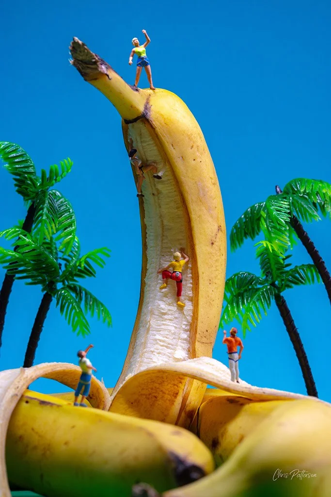 A banana with figurines climbing it