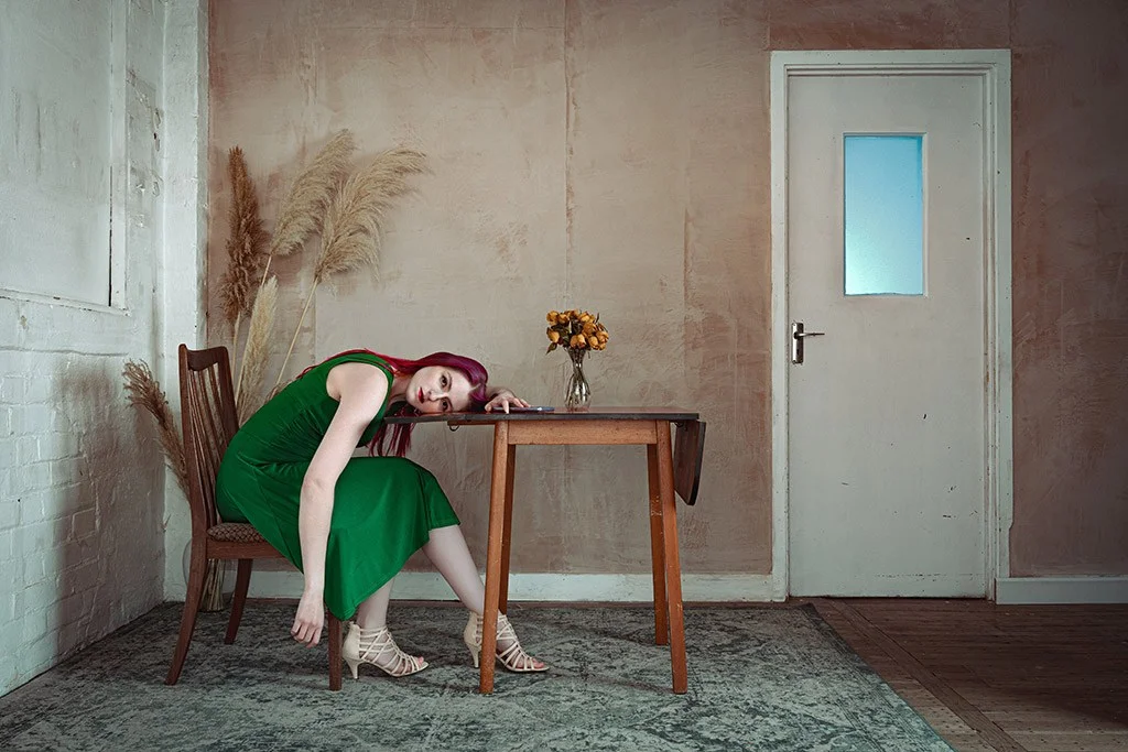 Woman in green dress at a table