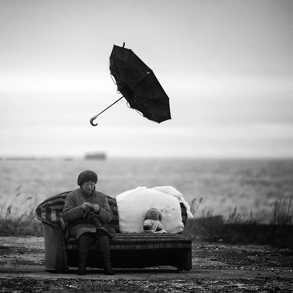 Woman outside with umbrella flying overhead