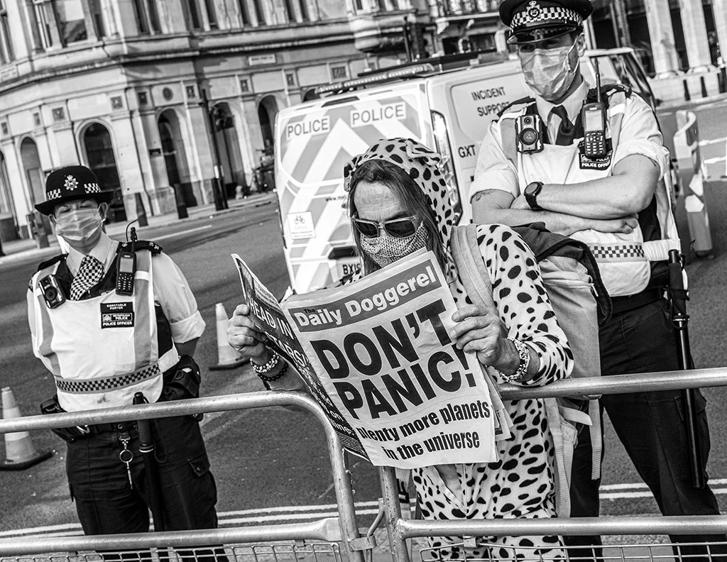Woman reading newspaper during protest