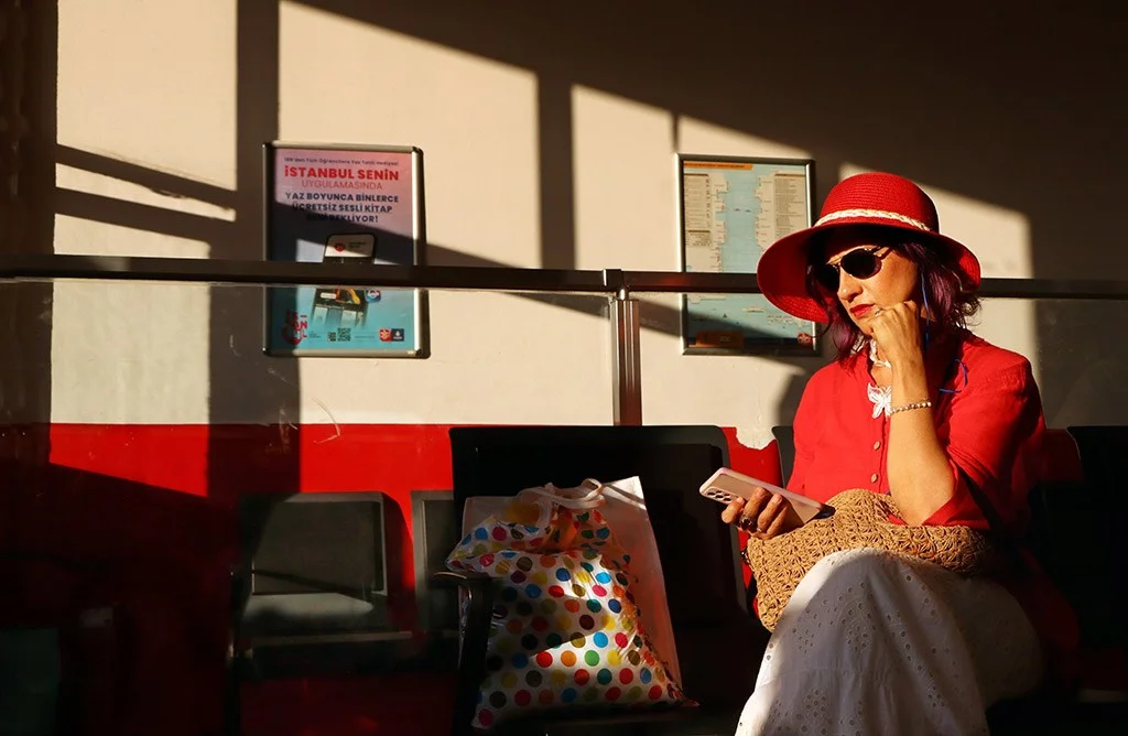 Woman dressed in red with long shadows