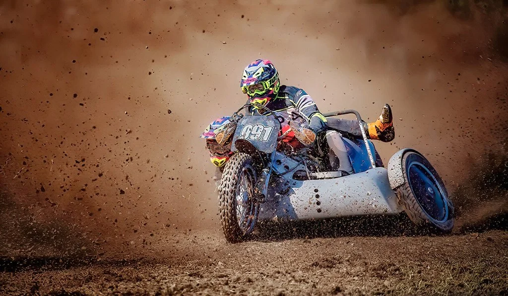 Motorsport captured mid-action with flying dirt