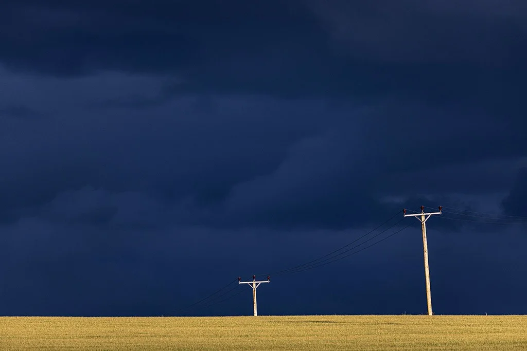 A landscape by Lynn Fraser depicting a vibrant sky with pylons